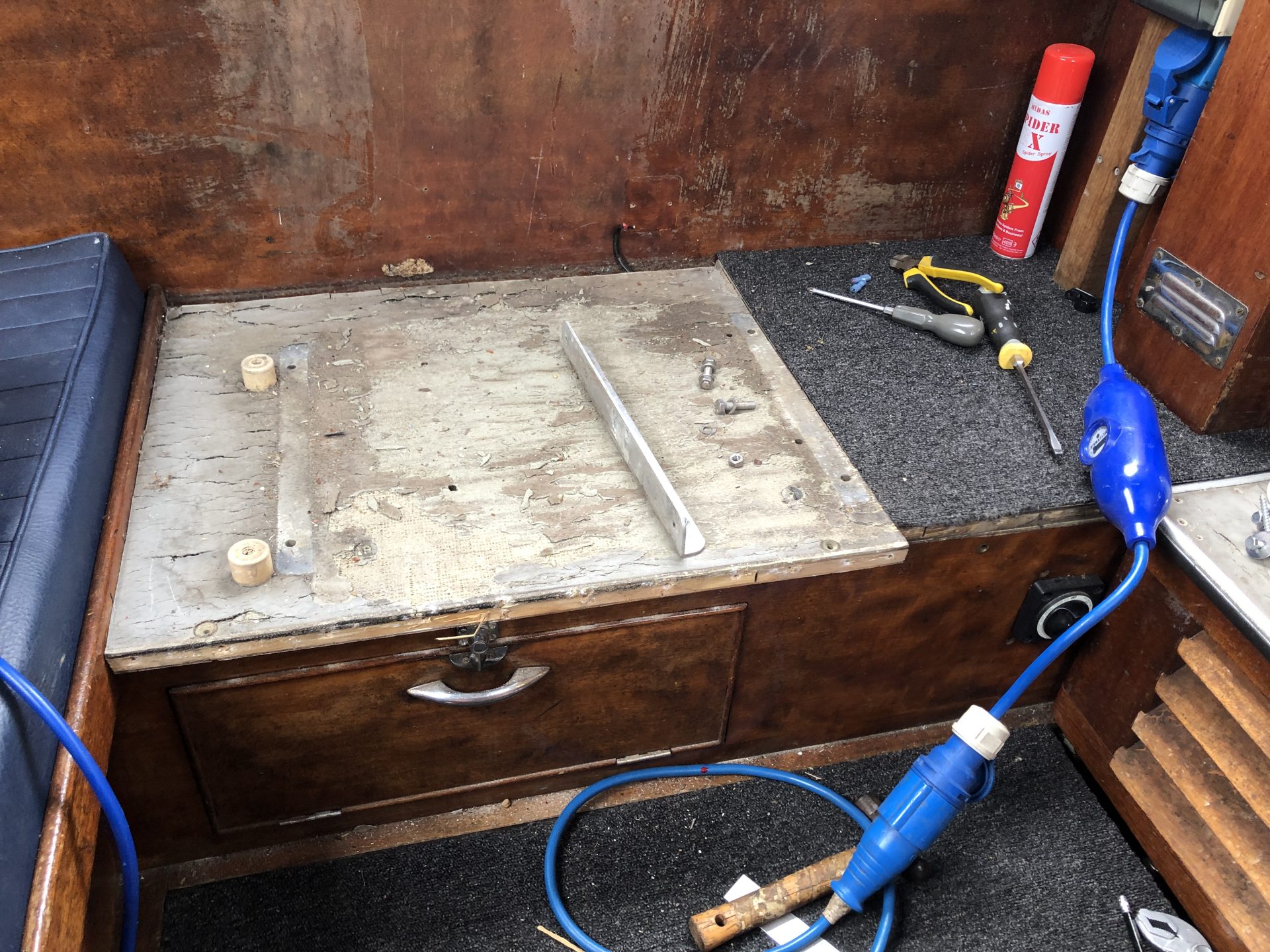 Helm plinth with the old seat and fridge box removed, show the horrible blockboard laminated flooring prior to removal