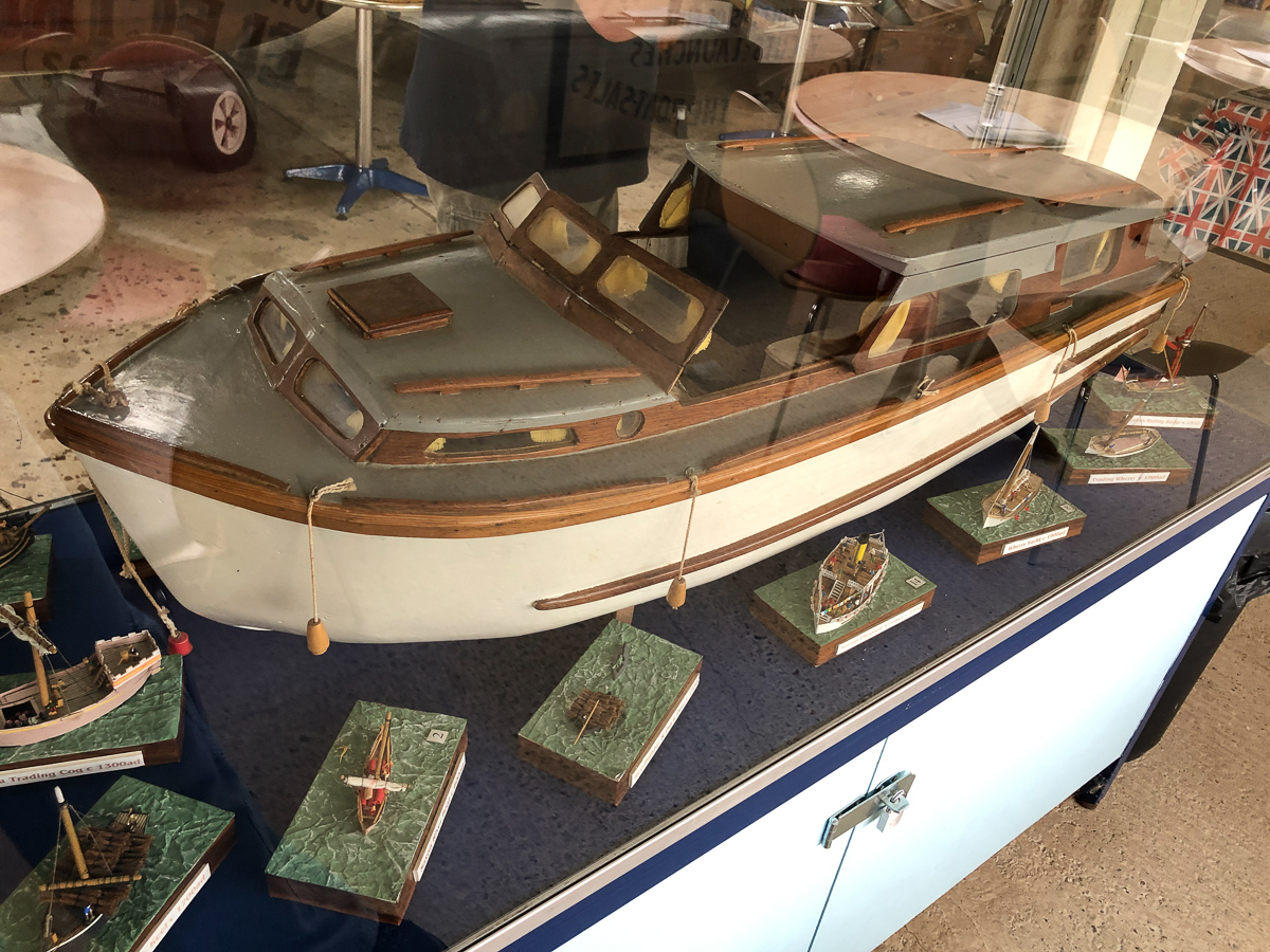 A museum exhibit showing a model of a classic broads cruiser
