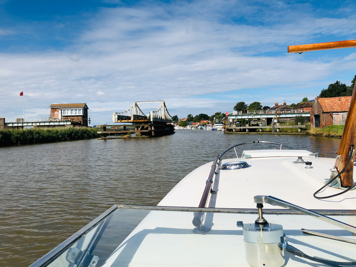Reedham and it's swing bridge open to allow a couple of gin palaces through