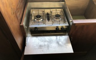The old cooker mounted in it's aluminium lined recess. Beware when removing the aluminium on the base as there is an asbestos sheet sandwiched underneath !