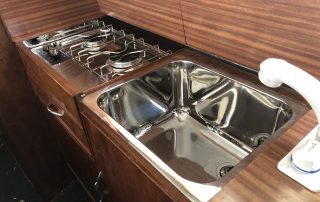 The cooker and sink mounted in place with the job very near complete