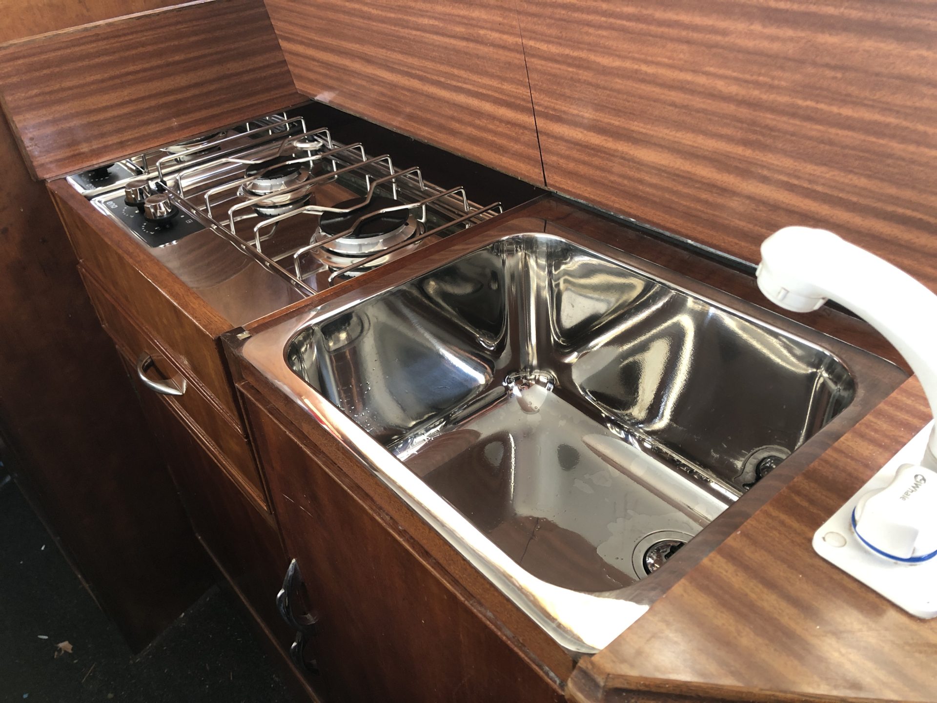 The cooker and sink mounted in place with the job very near complete